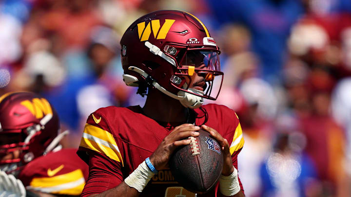 Sep 15, 2024; Landover, Maryland, USA; Washington Commanders quarterback Jayden Daniels (5) drops back to pass during the first quarter against the New York Giants at Commanders Field. Mandatory Credit: Peter Casey-Imagn Images