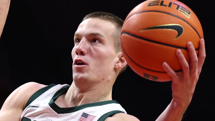 Jan 27, 2026; Piscataway, New Jersey, USA; Michigan State Spartans guard Denham Wojcik (10) goes to the basket against Rutgers Scarlet Knights guard Harun Zrno (13) during the first half at Jersey Mike's Arena.