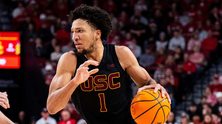 Jan 22, 2025; Lincoln, Nebraska, USA; Southern California Trojans guard Desmond Claude (1) drives against Nebraska Cornhuskers guard Connor Essegian (0) during the second half at Pinnacle Bank Arena. Mandatory Credit: Dylan Widger-Imagn Images