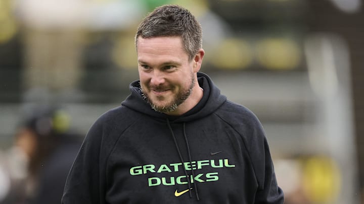 Oct 25, 2025; Eugene, Oregon, USA; Oregon Ducks head coach Dan Lanning encourages players during warm ups before a game against the Wisconsin Badgers at Autzen Stadium. The Ducks are wearing uniforms celebrating the Grateful Dead. Mandatory Credit: Troy Wayrynen-Imagn Images