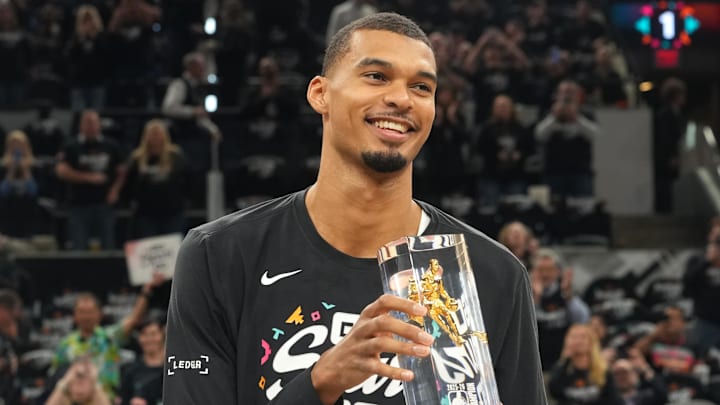 Apr 21, 2026; San Antonio, Texas, USA; San Antonio Spurs forward Victor Wembanyama (1) holds up his Defensive Player of the Year award before game two of the first round of the 2026 NBA Playoffs against the Portland Trail Blazers at Frost Bank Center. Mandatory Credit: Scott Wachter-Imagn Images