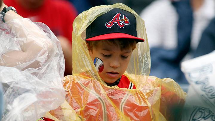 Jul 20, 2014; Atlanta, GA, USA; A young Atlanta Braves fan puts on his rain jacket during the game against the Philadelphia Phillies at Turner Field. The game was delayed because of rain in the sixth inning. Mandatory Credit: Jason Getz-USA TODAY Sports Jul 20, 2014; Atlanta, GA, USA; A young Atlanta Braves fan puts on his rain jacket during the game against the Philadelphia Phillies at Turner Field. The game was delayed because of rain in the sixth inning. Mandatory Credit: Jason Getz-USA TODAY Sports
