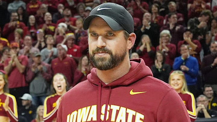 Iowa State football coach Jimmy Rogers speaks during a timeout in the first half in the Iowa State and Iowa men’s basketball Cy-Hawk series at Hilton coliseum on Dec. 11, 2025, in Ames, Iowa. Iowa State football coach Jimmy Rogers speaks during a timeout in the first half in the Iowa State and Iowa men’s basketball Cy-Hawk series at Hilton coliseum on Dec. 11, 2025, in Ames, Iowa.