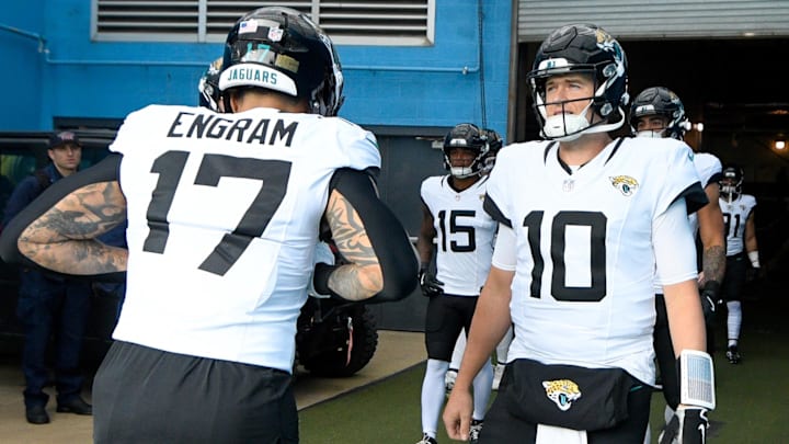 Dec 8, 2024; Nashville, Tennessee, USA;  Jacksonville Jaguars quarterback Mac Jones (10) and tight end Evan Engram (17) take the field against the Tennessee Titans during the first half at Nissan Stadium. Mandatory Credit: Steve Roberts-Imagn Images