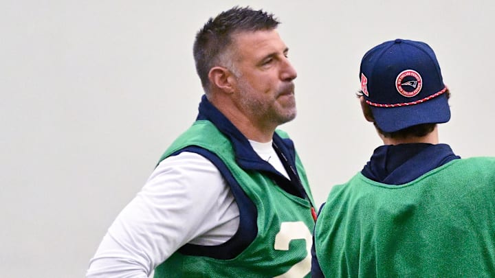 Jun 10, 2025; Foxborough, MA, USA; New England Patriots head coach Mike Vrabel (l) looks over a play with an assistant during minicamp held in the WIN Field House at Gillette Stadium. Mandatory Credit: Eric Canha-Imagn Images