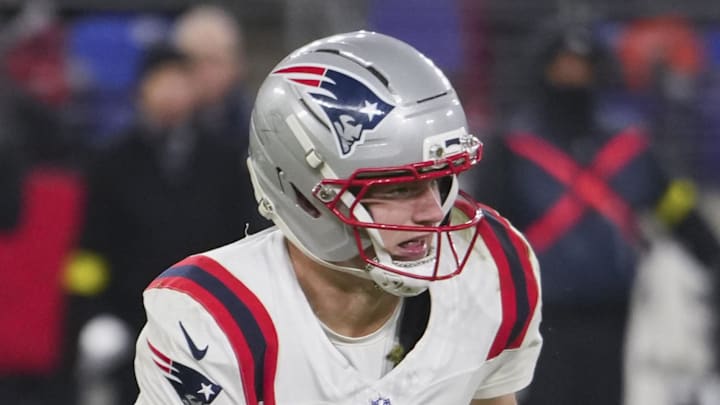 New England Patriots quarterback Drake Maye scrambles against Baltimore Ravens safety Alohi Gilman.