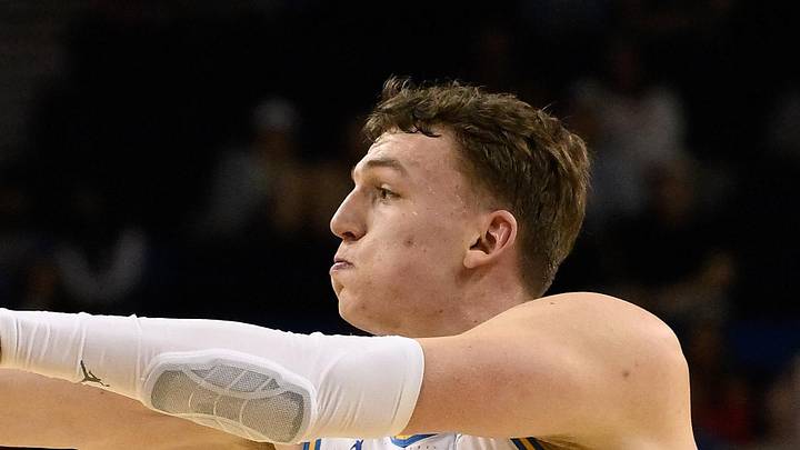 Mar 3, 2026; Los Angeles, California, USA; UCLA Bruins forward Tyler Bilodeau (34) passes the ball as Nebraska Cornhuskers forward Braden Frager (5) defends during the 1st half at Pauley Pavilion presented by Wescom Financial. Mandatory Credit: Robert Hanashiro-Imagn Images