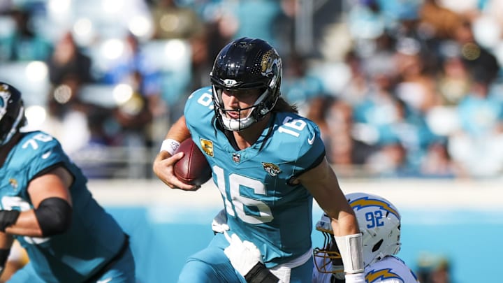 Nov 16, 2025; Jacksonville, Florida, USA; Jacksonville Jaguars quarterback Trevor Lawrence (16) rushes against Los Angeles Chargers defensive tackle Justin Eboigbe (92) during the third quarter at EverBank Stadium. Mandatory Credit: Nathan Ray Seebeck-Imagn Images