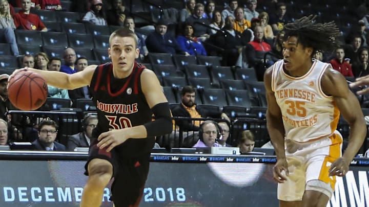 Nov 21, 2018; Brooklyn, NY, USA; Louisville Cardinals guard Ryan McMahon (30) drives past Tennessee Volunteers guard Yves Pons (35) in the first half against the during the NIT Tipoff at Barclays Center.