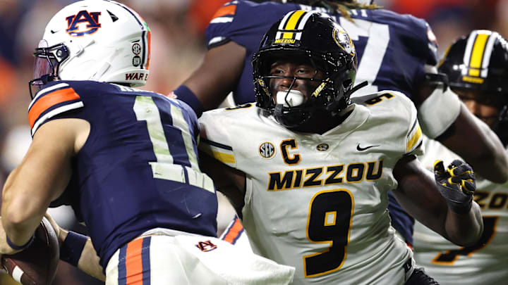 Missouri Tigers defensive end Zion Young (9) moves in to tackle Auburn Tigers quarterback Jackson Arnold (11). Missouri Tigers defensive end Zion Young (9) moves in to tackle Auburn Tigers quarterback Jackson Arnold (11).