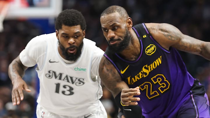 Jan 7, 2025; Dallas, Texas, USA; Los Angeles Lakers forward LeBron James (23) drives to the basket as Dallas Mavericks forward Naji Marshall (13)  defends during the second half at American Airlines Center. Mandatory Credit: Kevin Jairaj-Imagn Images