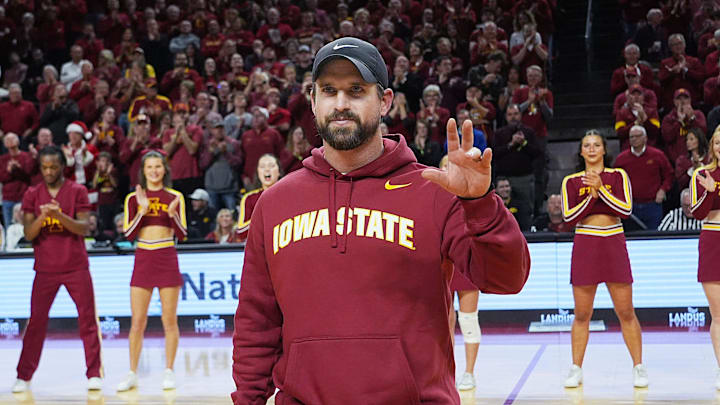 Iowa State football coach Jimmy Rogers speaks during a timeout in the first half in the Iowa State and Iowa men’s basketball Cy-Hawk series at Hilton coliseum on Dec. 11, 2025, in Ames, Iowa. Iowa State football coach Jimmy Rogers speaks during a timeout in the first half in the Iowa State and Iowa men’s basketball Cy-Hawk series at Hilton coliseum on Dec. 11, 2025, in Ames, Iowa.