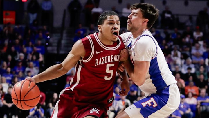 Arkansas Razorbacks guard Darius Acuff Jr. (5) drives the ball against Florida Gators guard Urban Klavzar (7) during the first half at Exactech Arena at the Stephen C. O'Connell Center. Mandatory Credit: Travis Register-Imagn Images