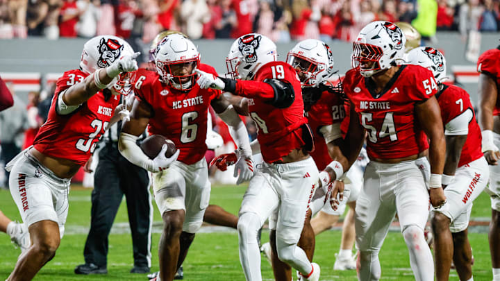 Nov 21, 2025; Raleigh, North Carolina, USA; NC State Wolfpack defensive back Devon Marshall (6) celebrates a down and runs towards the JROTC  to celebrate during the first half of the game against Florida State Seminoles at Carter-Finley Stadium. Mandatory Credit: Jaylynn Nash-Imagn Images