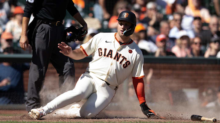Sep 29, 2024; San Francisco, California, USA; San Francisco Giants third baseman Casey Schmitt (10) slides home during the seventh inning against the St. Louis Cardinals at Oracle Park. 