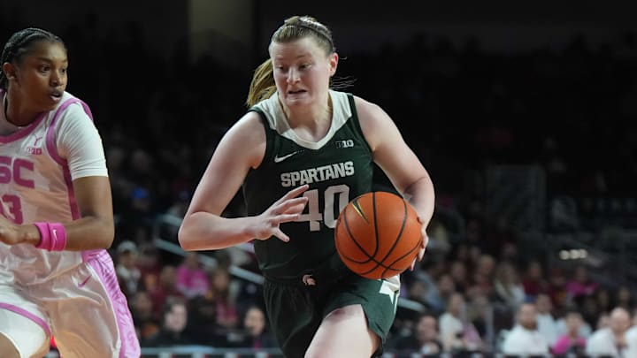 Feb 19, 2025; Los Angeles, California, USA; Michigan State Spartans guard Julia Ayrault (40) dribbles the ball against Southern California Trojans center Rayah Marshall (13) in the second half at the Galen Center. Mandatory Credit: Kirby Lee-Imagn Images