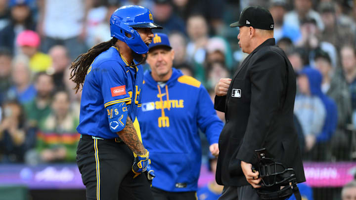 May 29, 2025; Seattle, Washington, USA; Seattle Mariners shortstop J.P. Crawford (3) interacts with home plate umpire Andy Fletcher after Crawford was ejected during the sixth inning of the game between Seattle Mariners and Washington Nationals at T-Mobile Park