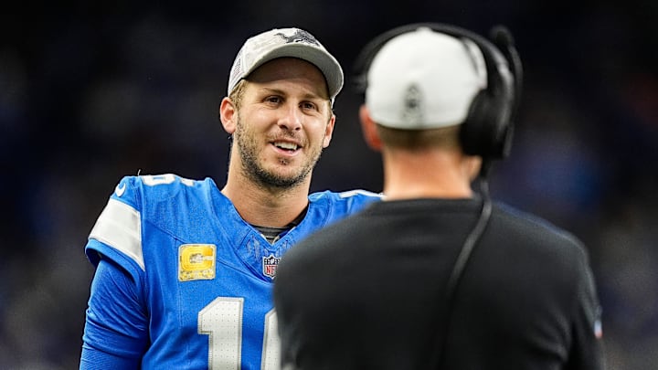 Detroit Lions quarterback Jared Goff (16) talks to offensive coordinator Ben Johnson 