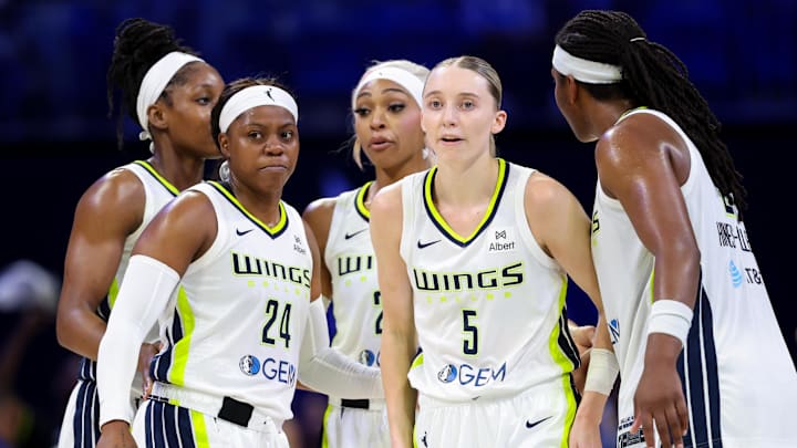 Jun 17, 2025; Arlington, Texas, USA;  Dallas Wings guard Paige Bueckers (5) and Dallas Wings guard Arike Ogunbowale (24) celebrates with teammates during the second half against the Golden State Valkyries at College Park Center. Mandatory Credit: Kevin Jairaj-Imagn Images