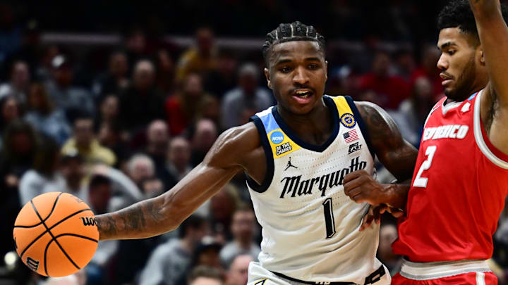 Mar 21, 2025; Cleveland, OH, USA; Marquette Golden Eagles guard Kam Jones (1) plays the ball defended by New Mexico Lobos guard Donovan Dent (2) in the second half during the NCAA Tournament First Round at Rocket Arena. Mandatory Credit: Ken Blaze-Imagn Images
