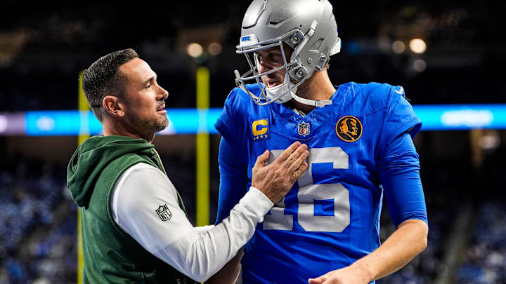 Detroit Lions quarterback Jared Goff (16), right, talks to Green Bay Packers head coach Matt LaFleur during warmup ahead of the Green Bay Packers game at Ford Field in Detroit on Thursday, Nov. 27, 2025.