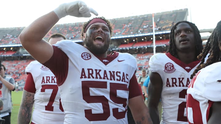 Arkansas Razorbacks offensive lineman Fernando Carmona (55) celebrates with fans after the Razorbacks beat the Auburn Tigers at Jordan-Hare Stadium. 