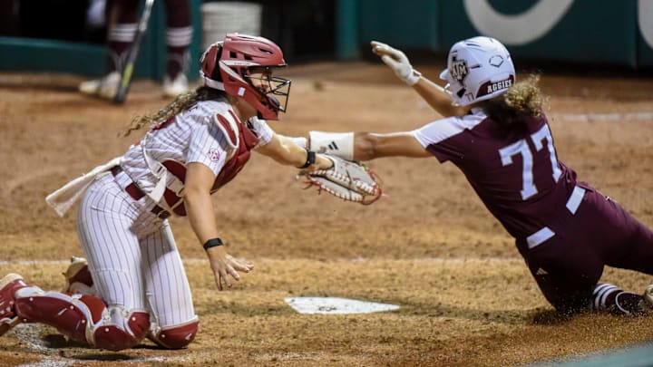 Alabama catcher Riley Valentine takes a throw and makes a tag to put out Texas A&M base runner Jazmine Hill 