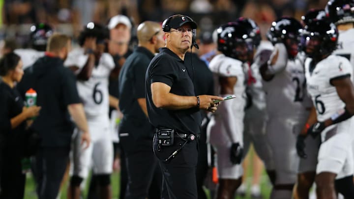 Sep 28, 2024; Lubbock, Texas, USA;  Cincinnati Bearcats head coach Scott Satterfield checks the scoreboard in the second half during the game against the Texas Tech Red Raiders at Jones AT&T Stadium and Cody Campbell Field. Mandatory Credit: Michael C. Johnson-Imagn Images