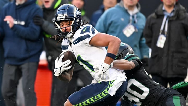 Dec 1, 2024; East Rutherford, New Jersey, USA; Seattle Seahawks wide receiver Jaxon Smith-Njigba (11) runs with the ball after a catch and is tackled by New York Jets cornerback Michael Carter II (30) during the third quarter at MetLife Stadium. Mandatory Credit: Mark Smith-Imagn Images