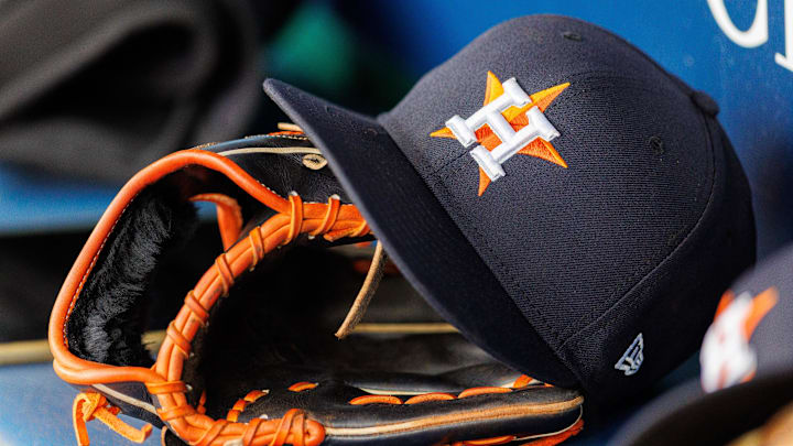 Apr 27, 2025; Kansas City, Missouri, USA; Houston Astros hat and glove in the dugout during the second inning against the Kansas City Royals at Kauffman Stadium. 
