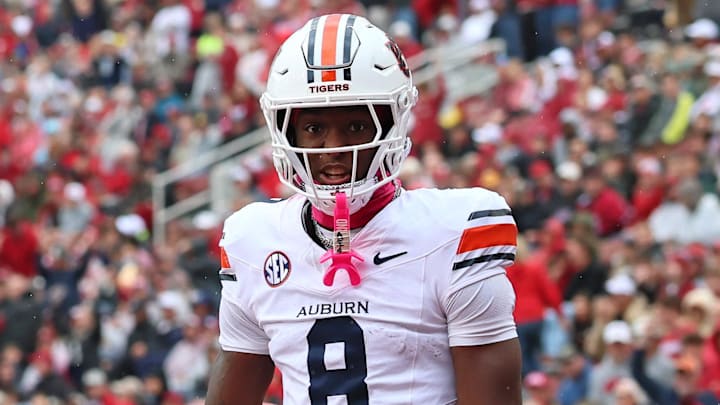 Auburn Tigers wide receiver Cam Coleman celebrates after scoring a touchdown defended by Arkansas Razorbacks defensive back Julian Neal during the first quarter at Donald W. Reynolds Razorback Stadium. 