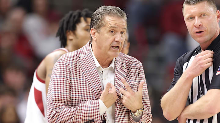 Arkansas Razorbacks coach John Calipari talks to an official during the first half against the Missouri Tigers at Bud Walton Arena in Fayetteville, Ark.