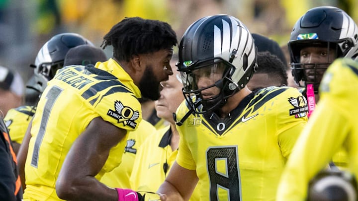 Oregon Ducks wide receiver Traeshon Holden, left, checks on quarterback Dillon Gabriel after Gabriel was hit as the Ducks host the Spartans Friday, Oct. 4, 2024 at Autzen Stadium in Eugene, Ore.