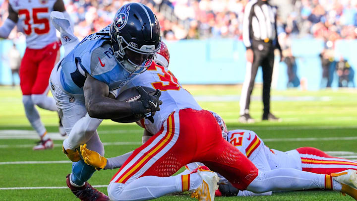 Dec 21, 2025; Nashville, Tennessee, USA;  Kansas City Chiefs linebacker Nick Bolton (32) tackles Tennessee Titans running back Tyjae Spears (2) short of the goal line during the second half at Nissan Stadium. Mandatory Credit: Steve Roberts-Imagn Images