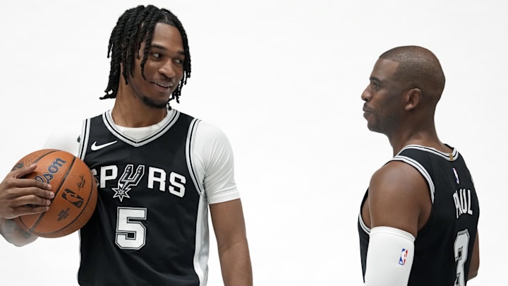 Sep 30, 2024; San Antonio, TX, USA; San Antonio Spurs guards Stephon Castle (5) and Chris Paul (3) pose for photos during Media day at Victory Capital Performance Center in San Antonio. Mandatory Credit: Scott Wachter-Imagn Images