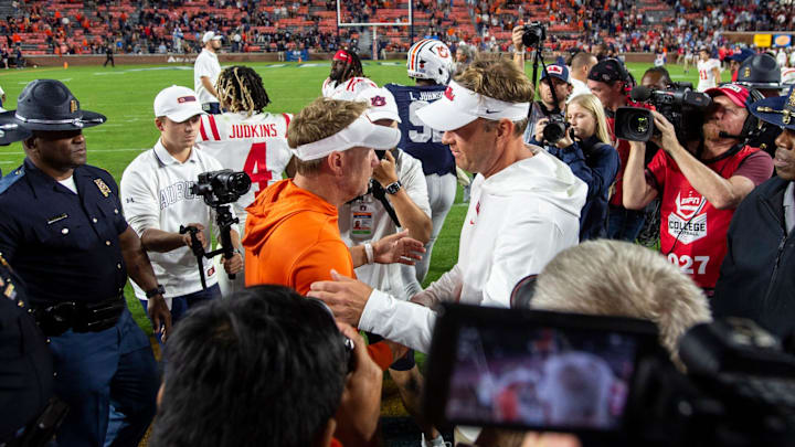 Auburn Tigers head coach Hugh Freeze and Ole Miss Rebels head coach Lane Kiffin shake hands after they met in 2023.