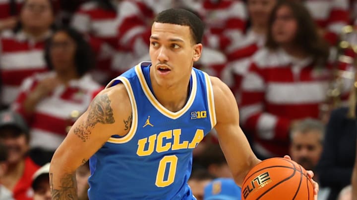 Dec 14, 2024; Phoenix, Arizona, USA; UCLA Bruins guard Kobe Johnson (0) against the Arizona Wildcats at Footprint Center. Mandatory Credit: Mark J. Rebilas-Imagn Images