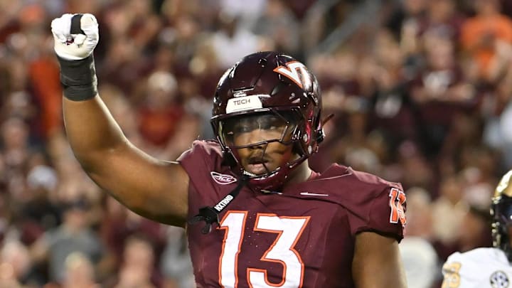 Sep 6, 2025; Blacksburg, Virginia, USA; Virginia Tech Hokies defensive lineman Kemari Copeland (13) celebrates a defensive stop during the first quarter at Lane Stadium. Mandatory Credit: Brian Bishop-Imagn Images