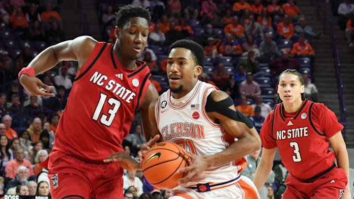 Clemson Tigers guard Ace Buckner (21) is defended by NC State Wolfpack forward Musa Sagnia (13) Tuesday, Jan. 20, 2026, during the NCAA men’s basketball game at Littlejohn Coliseum in Clemson, South Carolina.