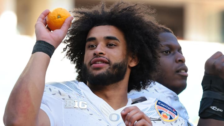 Jan 1, 2026; Miami Gardens, FL, USA; Oregon Ducks linebacker Devon Jackson (26) and quarterback Dante Moore (5) celebrate following the 2025 Orange Bowl and quarterfinal game of the College Football Playoff against the Texas Tech Red Raiders at Hard Rock Stadium. Mandatory Credit: Sam Navarro-Imagn Images Jan 1, 2026; Miami Gardens, FL, USA; Oregon Ducks linebacker Devon Jackson (26) and quarterback Dante Moore (5) celebrate following the 2025 Orange Bowl and quarterfinal game of the College Football Playoff against the Texas Tech Red Raiders at Hard Rock Stadium. Mandatory Credit: Sam Navarro-Imagn Images
