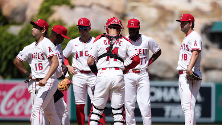Angels starting pitcher Yusei Kikuchi (16) is removed from the game by manager Ron Washington (37) as catcher Logan O'Hoppe (14), first baseman Nolan Schanuel (18) and second baseman Tim Anderson (77)  watch in the sixth inning against the San Francisco Giants at Angel Stadium.