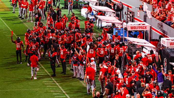 Sep 27, 2025; Raleigh, North Carolina, USA; North Carolina State Wolfpack bench celebrates during the second half of the game against Virginia Tech Hokies at Carter-Finley Stadium. Mandatory Credit: Jaylynn Nash-Imagn Images Sep 27, 2025; Raleigh, North Carolina, USA; North Carolina State Wolfpack bench celebrates during the second half of the game against Virginia Tech Hokies at Carter-Finley Stadium. Mandatory Credit: Jaylynn Nash-Imagn Images