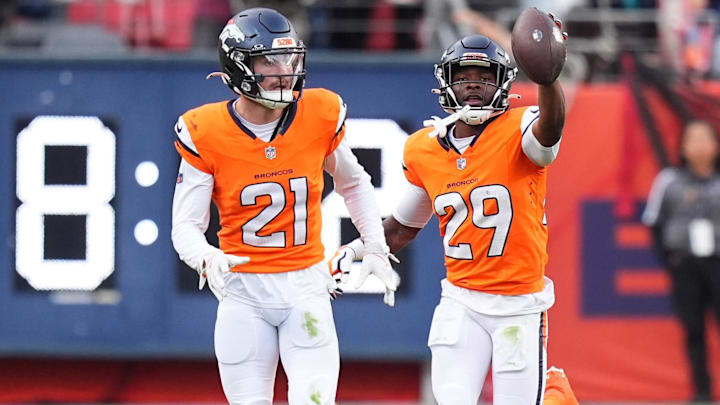 Oct 27, 2024; Denver, Colorado, USA; Denver Broncos cornerback Ja'Quan McMillian (29) celebrates his turnover with cornerback Riley Moss (21) in the second half against the Carolina Panthers at Empower Field at Mile High. 