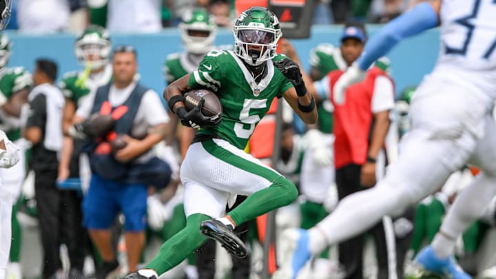 Sep 15, 2024; Nashville, Tennessee, USA;  New York Jets wide receiver Garrett Wilson (5) runs the ball against the Tennessee Titans during the second half at Nissan Stadium. Mandatory Credit: Steve Roberts-Imagn Images