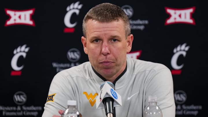 Feb 5, 2026; Cincinnati, Ohio, USA;  West Virginia Mountaineers head coach Ross Hodge answers media questions after his team’s game against the Cincinnati Bearcats at Fifth Third Arena. Mandatory Credit: Aaron Doster-Imagn Images