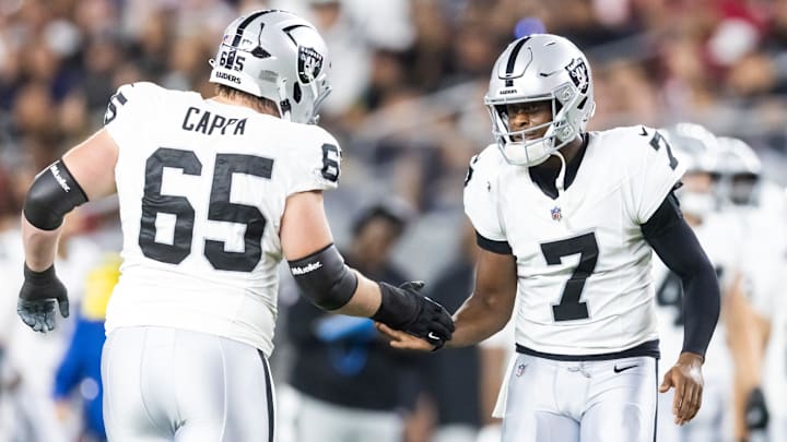 Aug 23, 2025; Glendale, Arizona, USA; Las Vegas Raiders quarterback Geno Smith (7) with guard Alex Cappa (65) against the Arizona Cardinals during a preseason NFL game at State Farm Stadium. Mandatory Credit: Mark J. Rebilas-Imagn Images