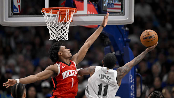 Feb 8, 2025; Dallas, Texas, USA; Dallas Mavericks guard Kyrie Irving (11) and Houston Rockets forward Amen Thompson (1) in action during the game between the Dallas Mavericks and the Houston Rockets at the American Airlines Center. Mandatory Credit: Jerome Miron-Imagn Images