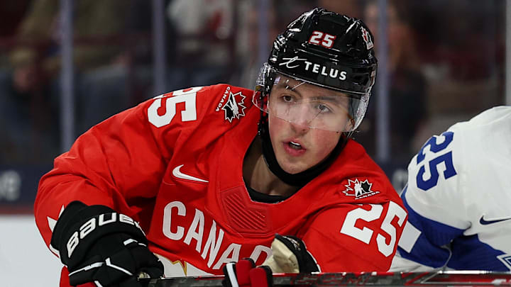Dec 31, 2025; Minneapolis, Minnesota, UNITED STATES; Canada forward Caleb Desnoyers (25) and Finland defenseman Lasse Boelius (25) compete for the puck during the second period in group play during the 2026 IIHF World Junior Championship at 3M Arena. Mandatory Credit: Matt Krohn-Imagn Images