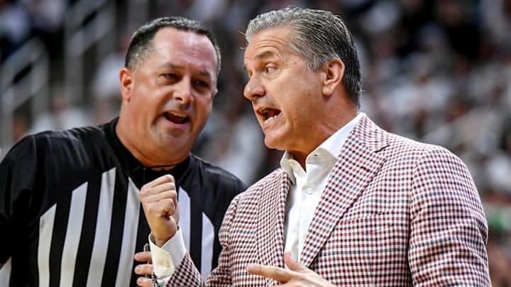 Arkansas coach John Calipari, right, argues with a referee during the first half against Michigan State.