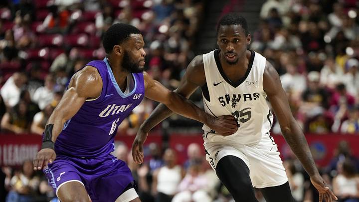 Jul 14, 2025; Las Vegas, NV, USA; San Antonio Spurs forward David Jones-Garcia (25) dribbles the ball against Utah Jazz guard Elijah Harkless (16) during the second half of a NBA basketball game at the Thomas & Mack Center. Mandatory Credit: Lucas Peltier-Imagn Images